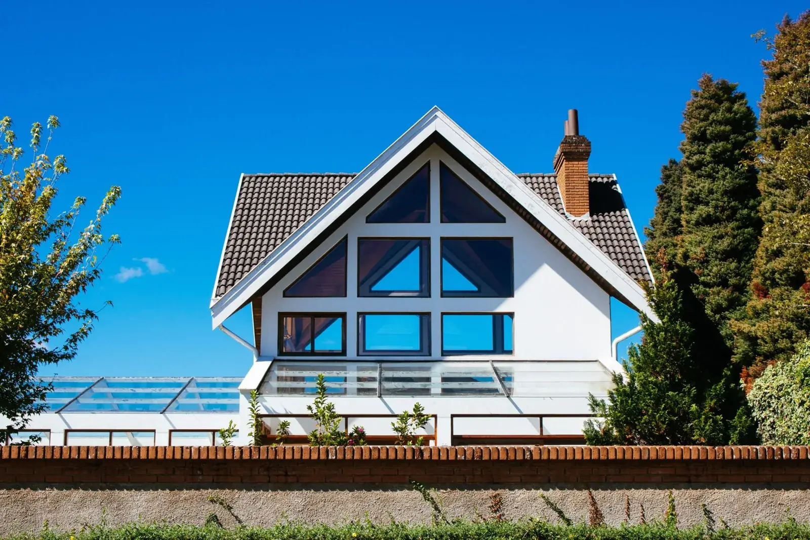 Contemporary A-frame house with large glass, the kind of home we buy in Bolivar Peninsula