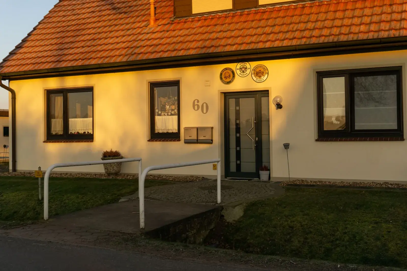 A well-lit, picturesque entrance of a modern, the kind of home we buy in Bonney