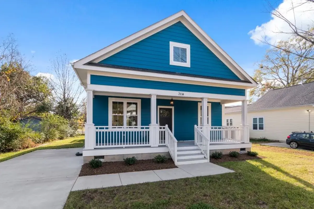 Exterior view of a blue suburban, the kind of home we buy in Brookside Village