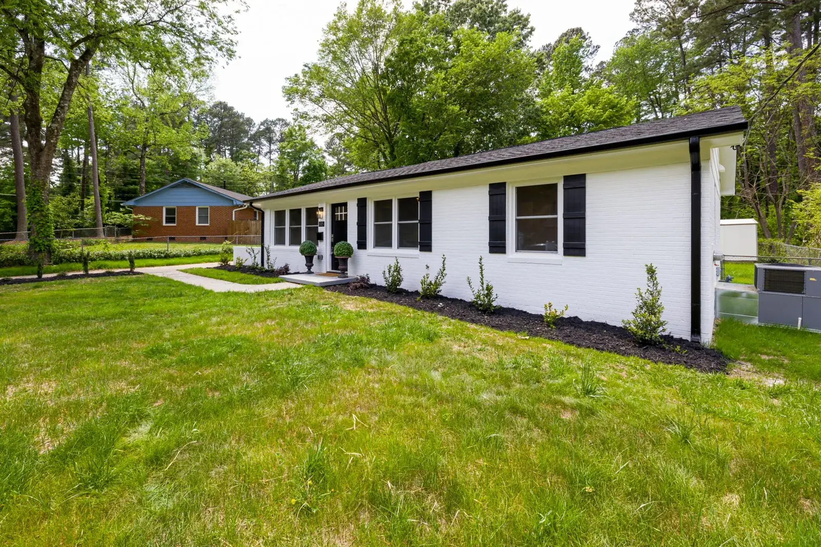 A modern suburban home with a lush, the kind of home we buy in Clute
