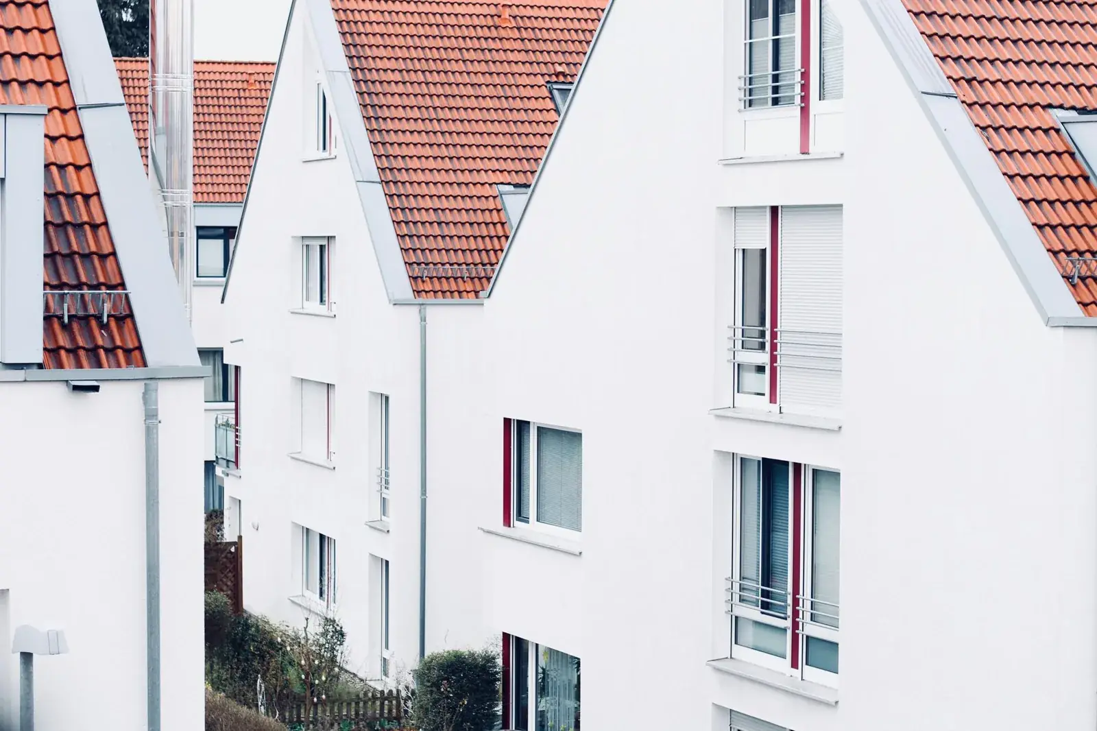White houses with red roofs create, the kind of home we buy in Galena Park