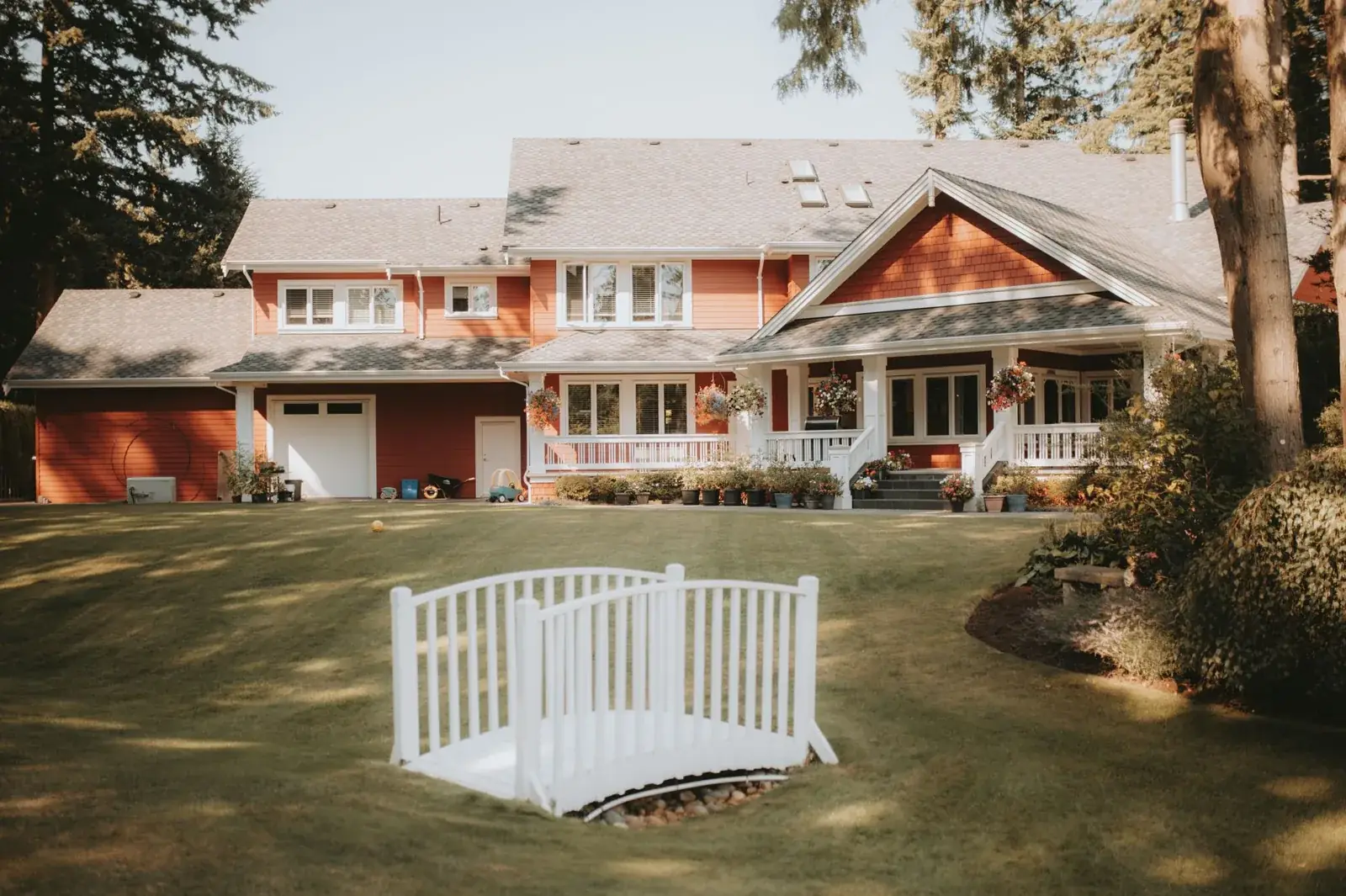 Charming red house with a large yard, the kind of home we buy in Grangerland