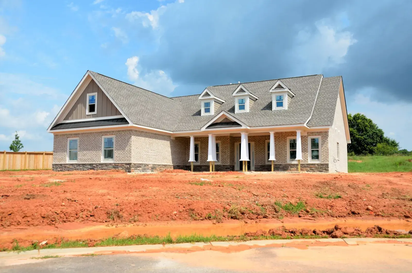 Brick modern family home under bright sky, the kind of home we buy in Highlands