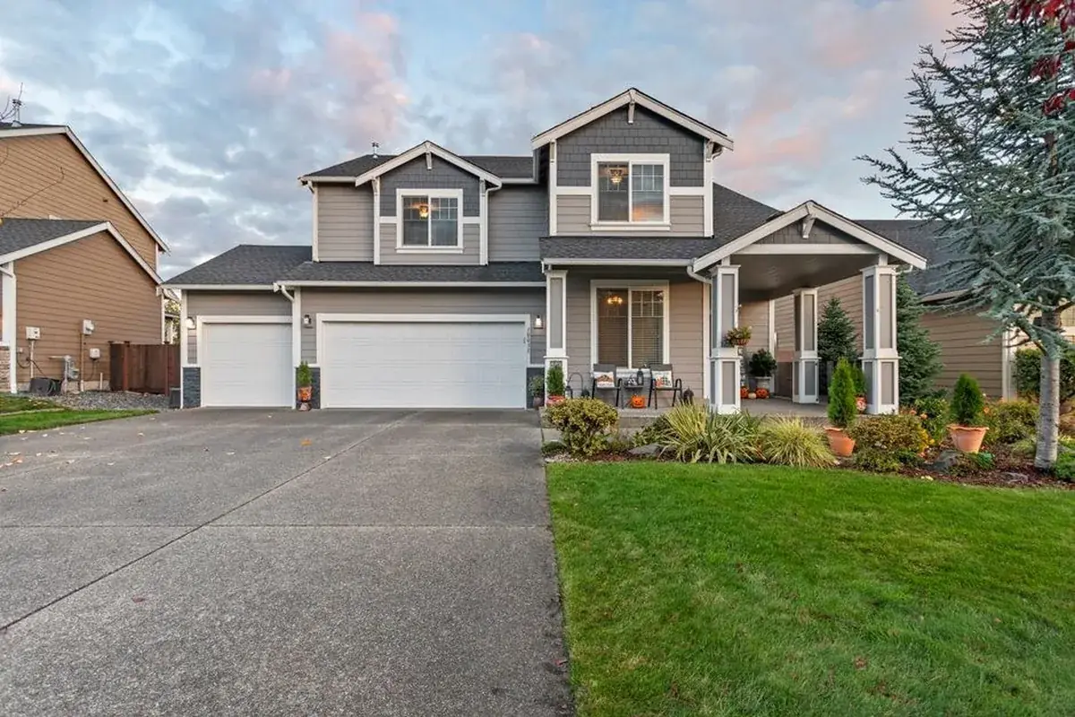 Charming two-story house with manicured lawn, the kind of home we buy in Jersey Village