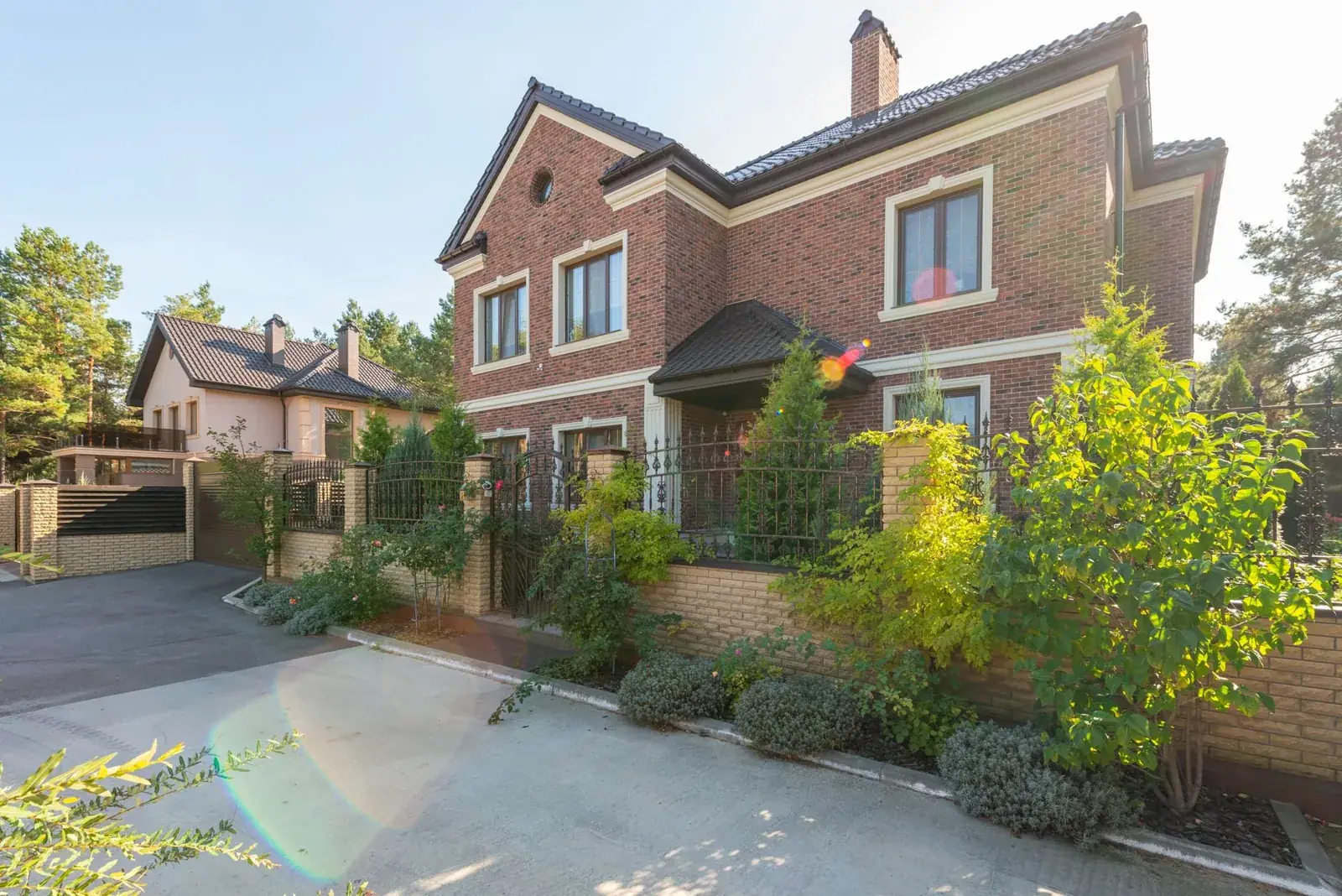 Elegant brick house with a lush garden, the kind of home we buy in Kendleton