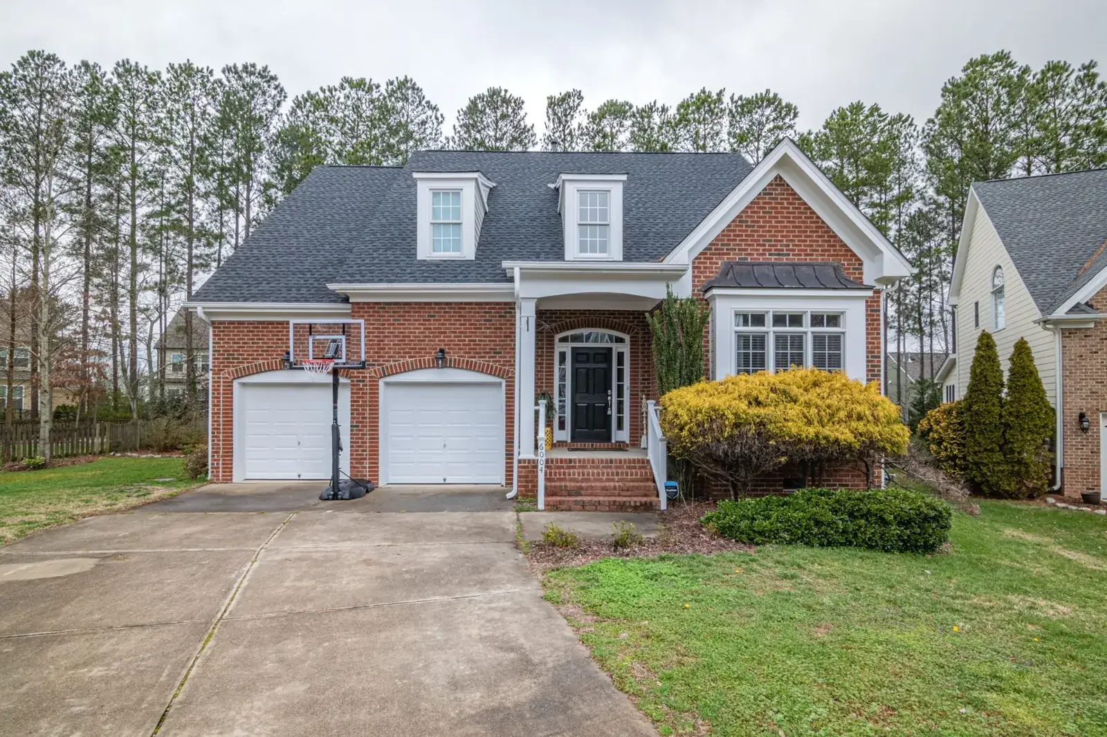 Brick suburban home with garage, the kind of home we buy in League City