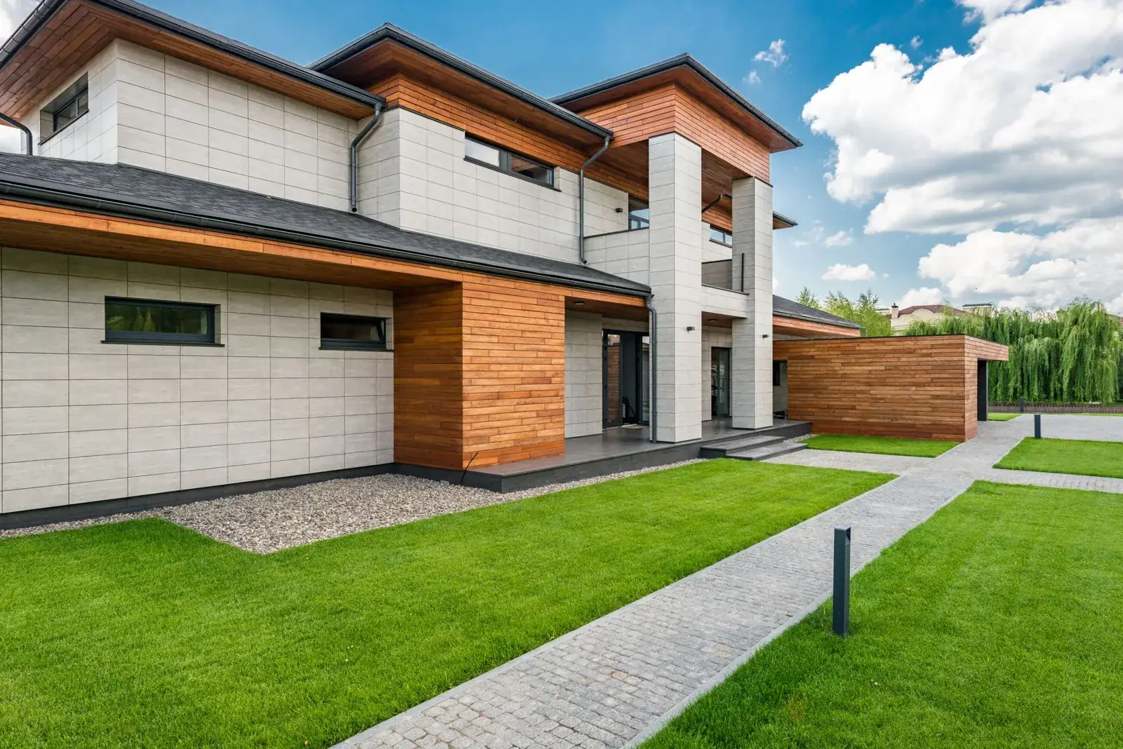 Exterior of contemporary residential house with green, the kind of home we buy in Montgomery