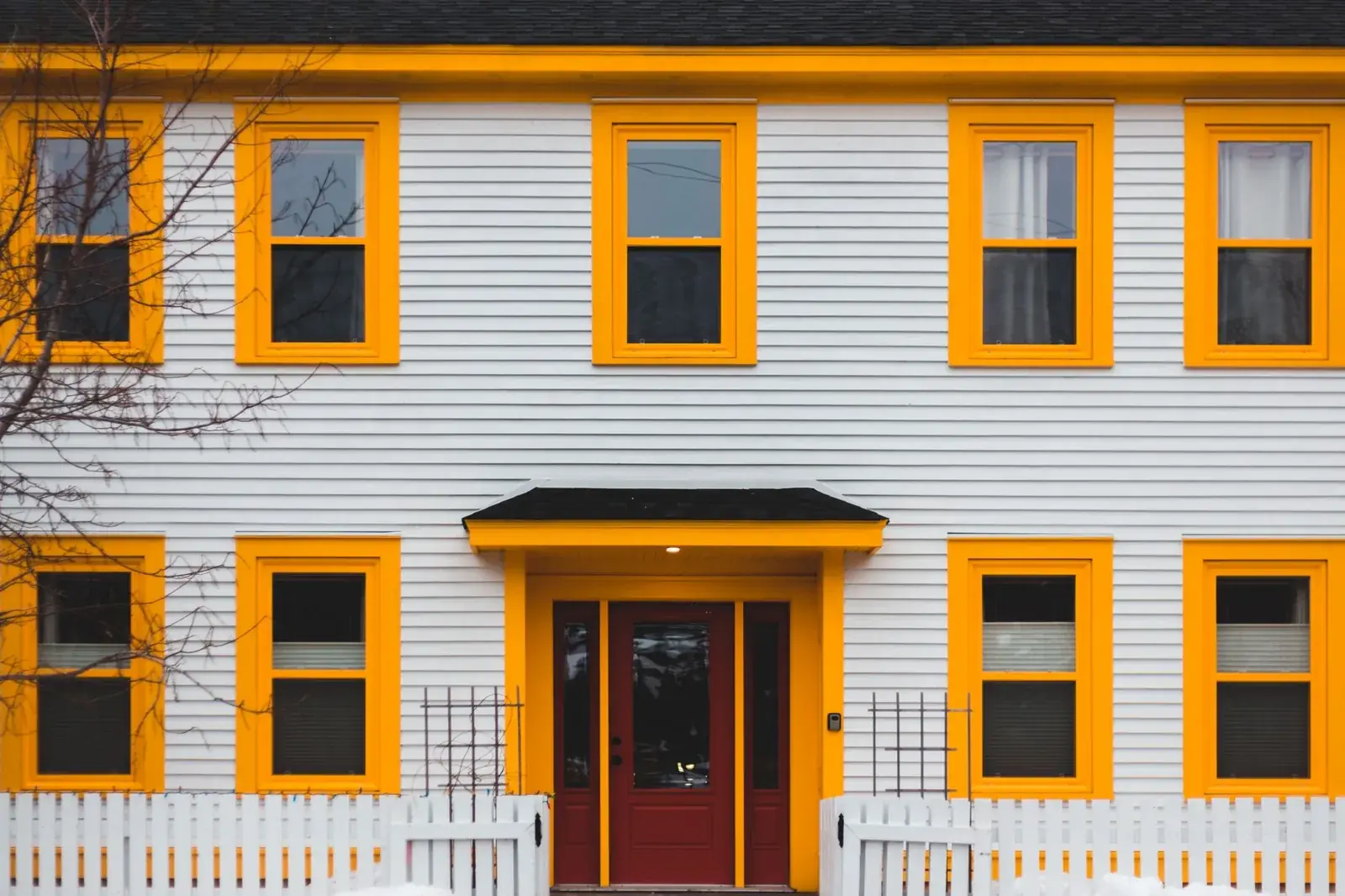 A vibrant yellow-trimmed house, the kind of home we buy in Port Bolivar