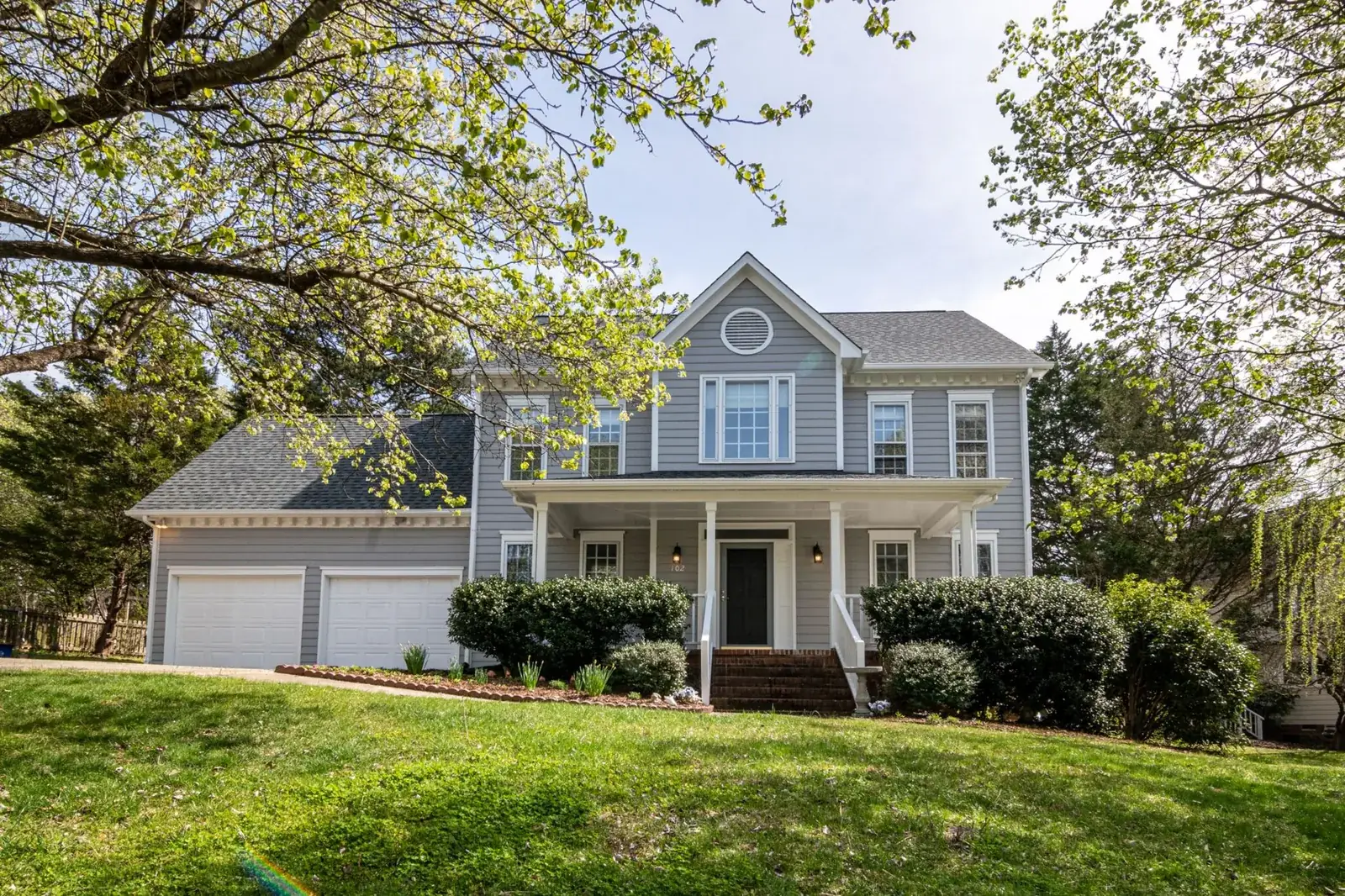 A beautiful suburban house surrounded by trees, the kind of home we buy in Sheldon