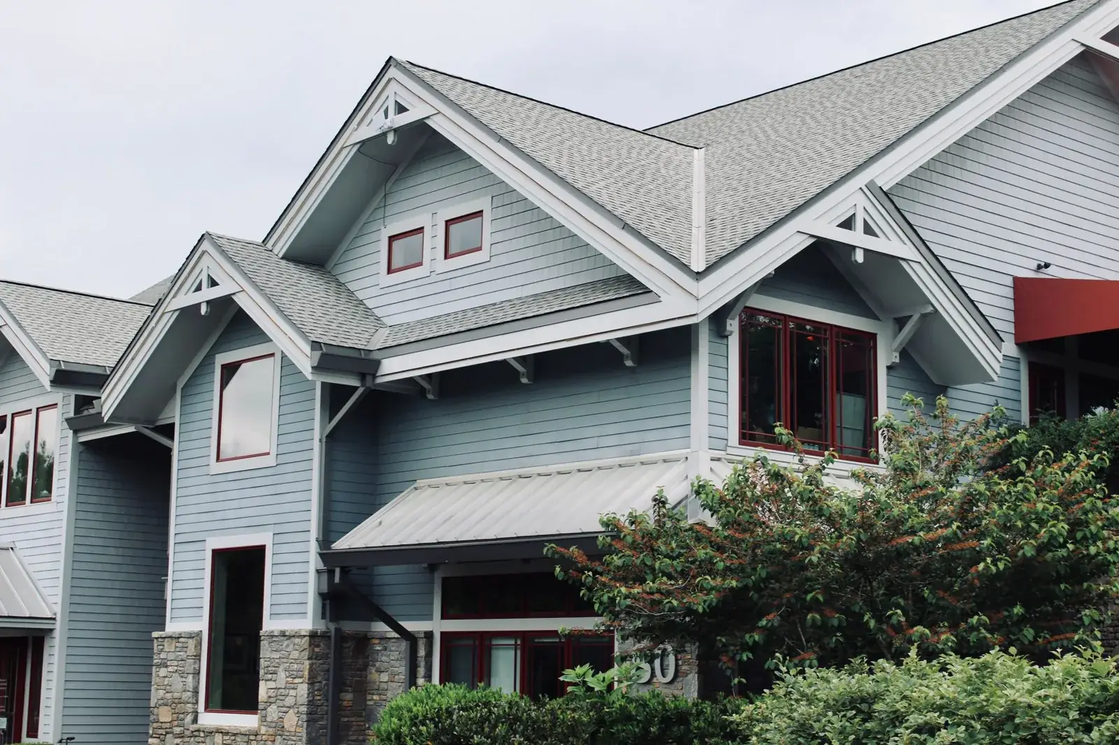 Charming blue house exterior with modern architectural, the kind of home we buy in Willis